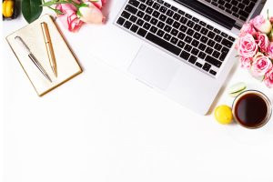 ariel photo of a desk with a laptop and notepad