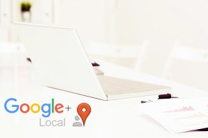 White laptop on a white desk with the Google Local logo over the photo