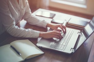 businesswoman typing on laptop at workplace woman working in office hand keyboard-img-blog